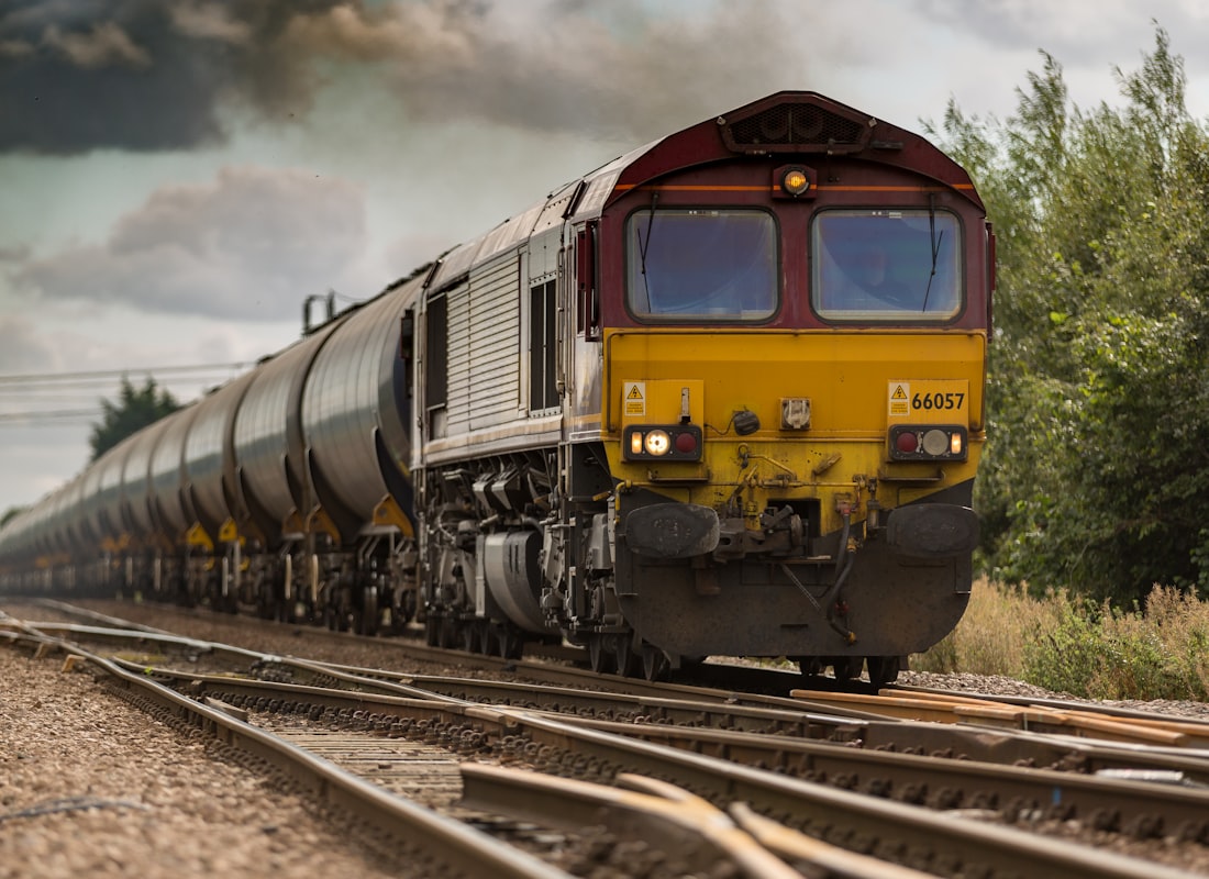Freight train carrying containers through open terrain